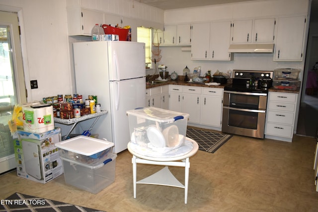 106 Walnut St, New Tazewell, TN 37825 - kitchen with range with two ovens, freestanding refrigerator, under cabinet range hood, light flooring, and white cabinets