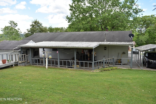 106 Walnut St, New Tazewell, TN 37825 - rear view of house with metal roof and a lawn
