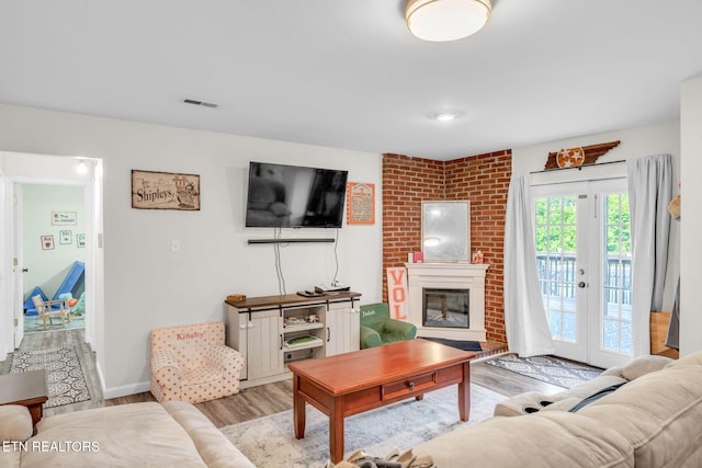 6608 Hickory Way Ln, Knoxville, TN 37918 - living room featuring wood finished floors, a brick fireplace, and baseboards