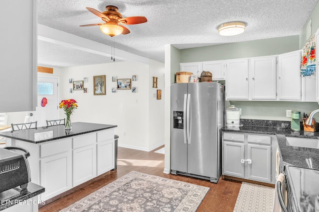 6608 Hickory Way Ln, Knoxville, TN 37918 - kitchen with stainless steel appliances, a sink, white cabinetry, wood finished floors, and a textured ceiling