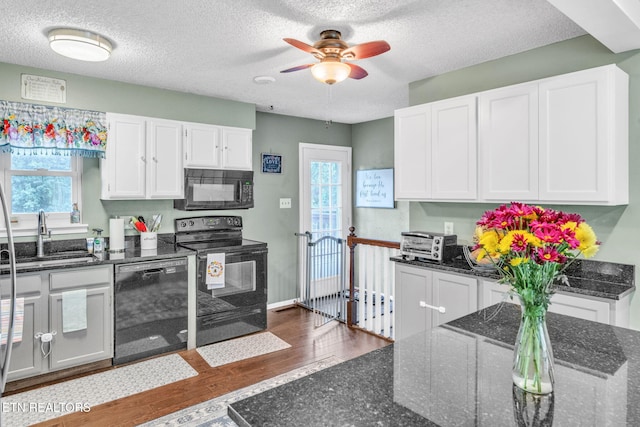 6608 Hickory Way Ln, Knoxville, TN 37918 - kitchen with black appliances, a sink, wood finished floors, white cabinetry, and a ceiling fan