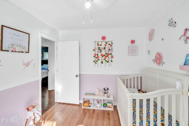 6608 Hickory Way Ln, Knoxville, TN 37918 - bedroom featuring a crib and wood finished floors