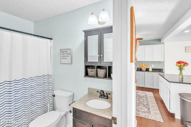 6608 Hickory Way Ln, Knoxville, TN 37918 - full bath with a textured ceiling, wood finished floors, toilet, vanity, and curtained shower