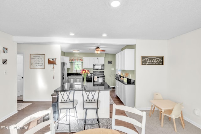 6608 Hickory Way Ln, Knoxville, TN 37918 - dining area featuring ceiling fan, baseboards, a textured ceiling, recessed lighting, and wood finished floors