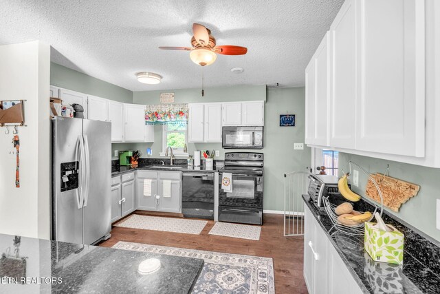 6608 Hickory Way Ln, Knoxville, TN 37918 - kitchen featuring black appliances, a sink, wood finished floors, white cabinets, and a textured ceiling