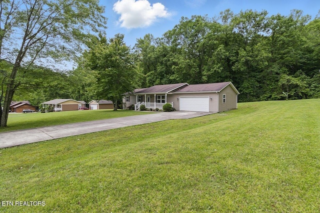 68 Pine Mountain Cir, Pineville, KY 40977 - ranch-style house with concrete driveway, a front yard, and a garage