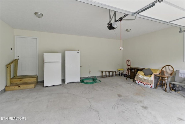 68 Pine Mountain Cir, Pineville, KY 40977 - garage featuring freestanding refrigerator and a garage door opener