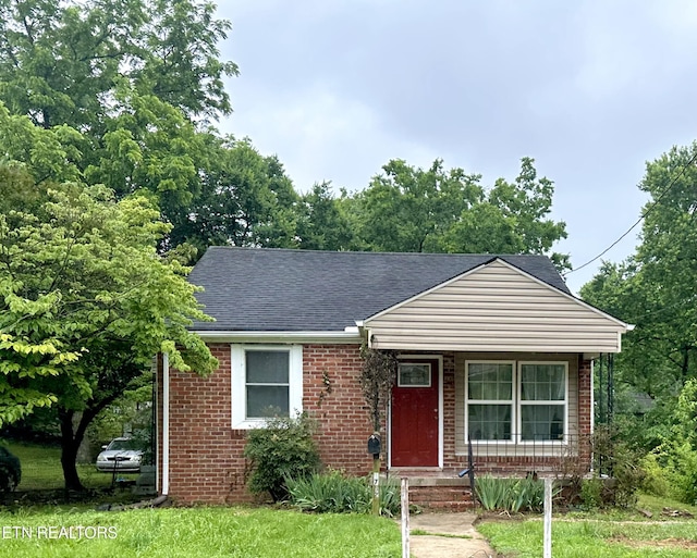 1732 Beaumont Ave, Knoxville, TN 37921 - bungalow with brick siding, roof with shingles, a porch, and a front yard