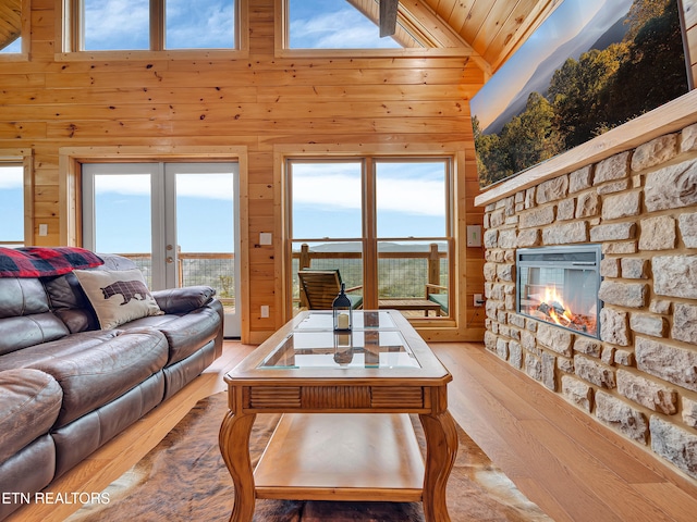 1027 Leslie Way, Sevierville, TN 37876 - living room with wood walls, french doors, light wood-style floors, a fireplace, and wood ceiling
