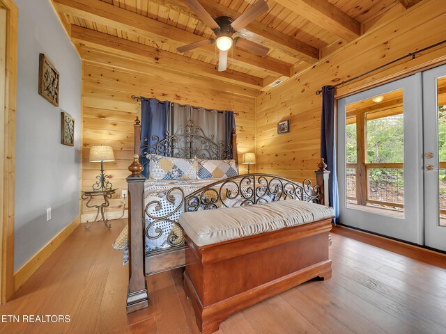 1027 Leslie Way, Sevierville, TN 37876 - bedroom featuring wooden ceiling with exposed beams, access to outside, wood walls, hardwood / wood-style flooring, and baseboards