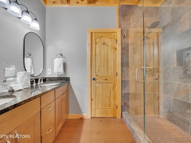 1027 Leslie Way, Sevierville, TN 37876 - bathroom featuring a stall shower, double vanity, wood finished floors, and a textured wall