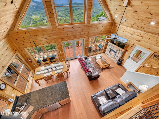 1027 Leslie Way, Sevierville, TN 37876 - living area with high vaulted ceiling, wood walls, healthy amount of natural light, wood finished floors, and wooden ceiling