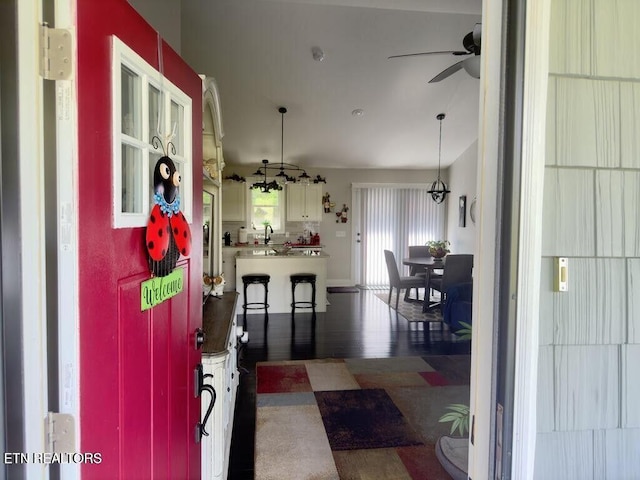 323 Wilson Hurst St, Tazewell, TN 37879 - kitchen featuring a ceiling fan, white cabinets, hanging light fixtures, and wood finished floors