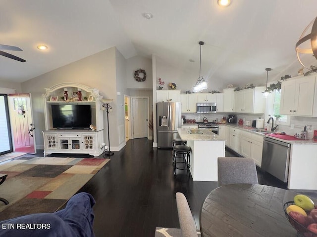 323 Wilson Hurst St, Tazewell, TN 37879 - kitchen featuring stainless steel appliances, open floor plan, white cabinetry, vaulted ceiling, and a kitchen island