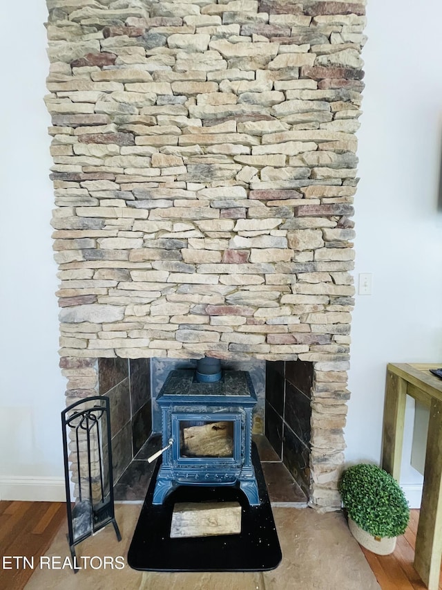 5422 Cricket Ln, Walland, TN 37886 - detailed view of a wood stove, wood finished floors, and baseboards