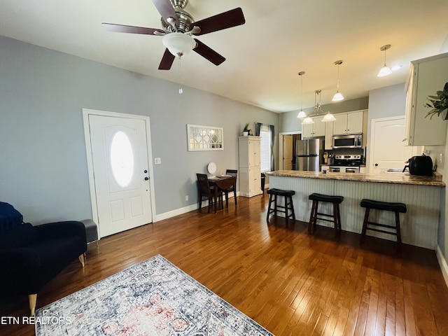 5422 Cricket Ln, Walland, TN 37886 - living room with dark wood-style floors, ceiling fan, and baseboards