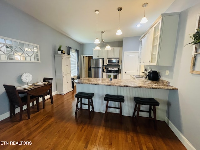 5422 Cricket Ln, Walland, TN 37886 - kitchen featuring stainless steel appliances, a peninsula, a sink, glass insert cabinets, and dark wood-type flooring