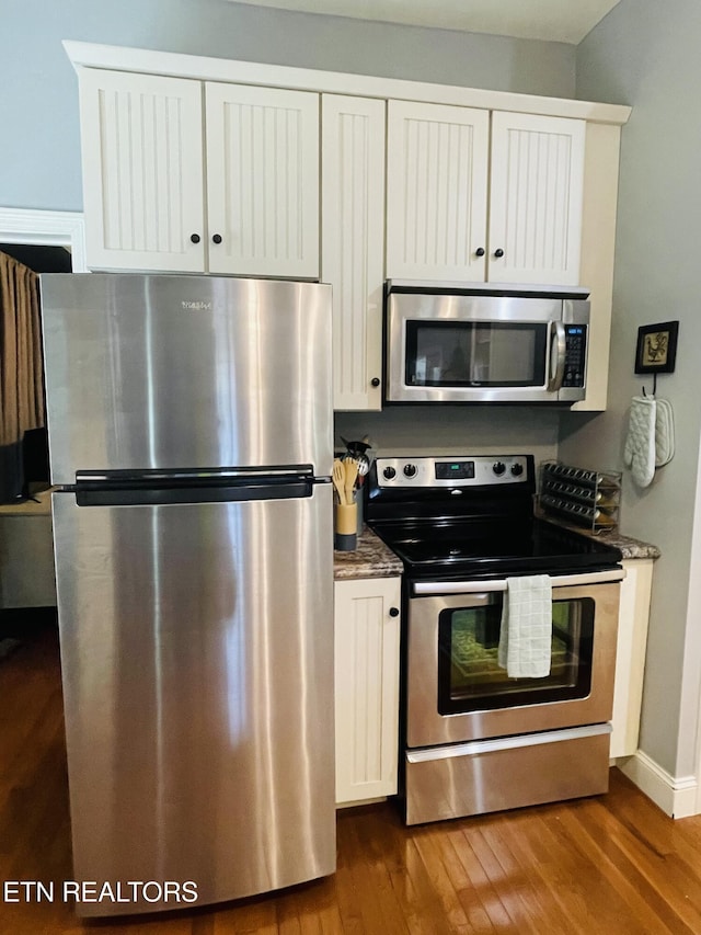 5422 Cricket Ln, Walland, TN 37886 - kitchen featuring stainless steel appliances, dark wood finished floors, white cabinets, and dark stone counters