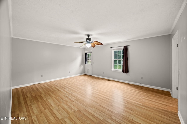 1036 Hawthorn Dr, Cookeville, TN 38501 - spare room with a textured ceiling, a ceiling fan, light wood-style floors, baseboards, and ornamental molding