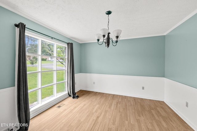 1036 Hawthorn Dr, Cookeville, TN 38501 - unfurnished room with a textured ceiling, a chandelier, wood finished floors, baseboards, and crown molding