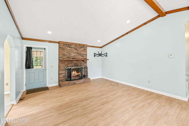1036 Hawthorn Dr, Cookeville, TN 38501 - unfurnished living room with light wood-style flooring, baseboards, a brick fireplace, arched walkways, and recessed lighting
