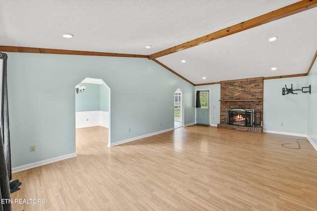 1036 Hawthorn Dr, Cookeville, TN 38501 - unfurnished living room with light wood-type flooring, baseboards, arched walkways, recessed lighting, and a textured ceiling