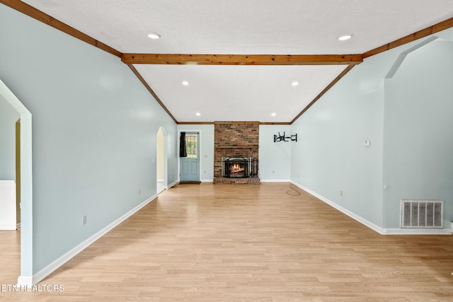 1036 Hawthorn Dr, Cookeville, TN 38501 - unfurnished living room with light wood-type flooring, arched walkways, baseboards, recessed lighting, and a fireplace