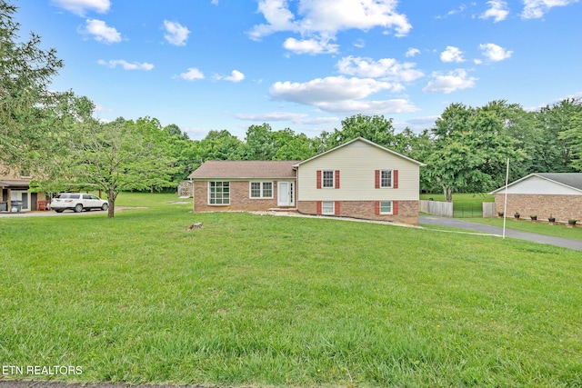 1036 Hawthorn Dr, Cookeville, TN 38501 - split level home with a front yard, brick siding, and view of scattered trees