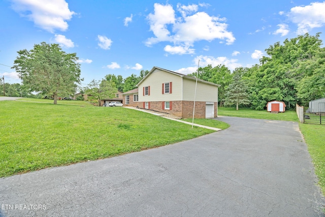 1036 Hawthorn Dr, Cookeville, TN 38501 - view of property exterior featuring asphalt driveway, a yard, a garage, and brick siding