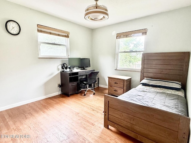 4721 Springcrest Dr, Knoxville, TN 37914 - bedroom featuring multiple windows, light wood-style floors, a desk, and baseboards