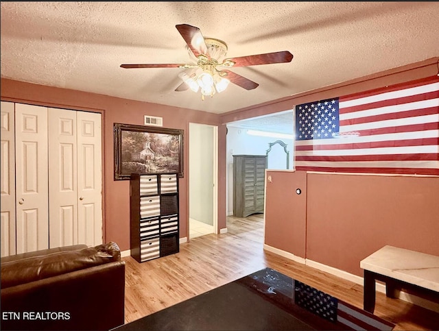 4721 Springcrest Dr, Knoxville, TN 37914 - living room with wood finished floors, a ceiling fan, a textured ceiling, and baseboards