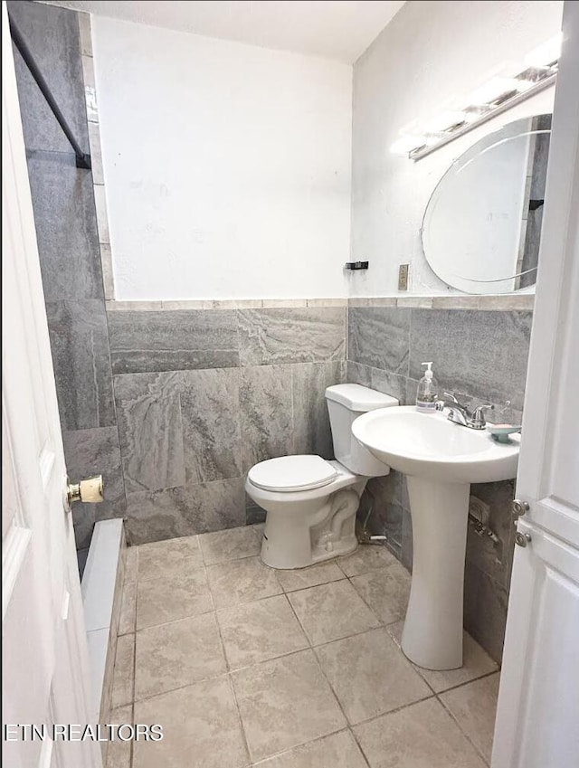 4721 Springcrest Dr, Knoxville, TN 37914 - bathroom with tile walls, toilet, a wainscoted wall, tile patterned flooring, and a sink