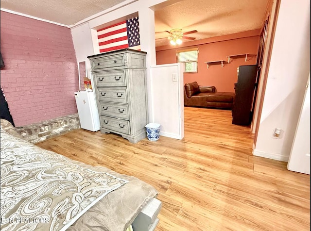 4721 Springcrest Dr, Knoxville, TN 37914 - bedroom with a textured ceiling, light wood finished floors, and brick wall
