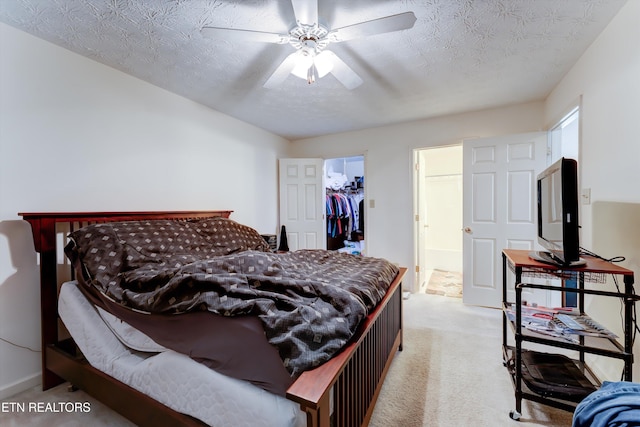 692 Shadywood Ln, Knoxville, TN 37923 - bedroom featuring carpet floors, a walk in closet, a closet, a ceiling fan, and a textured ceiling