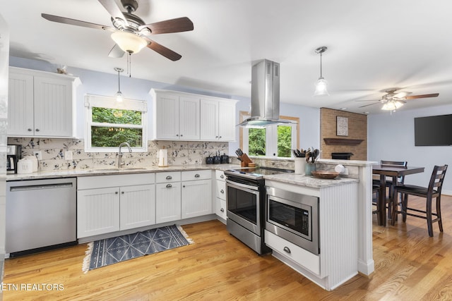 120 Cooper Cir, Oak Ridge, TN 37830 - kitchen featuring stainless steel appliances, island range hood, a ceiling fan, a sink, and a peninsula
