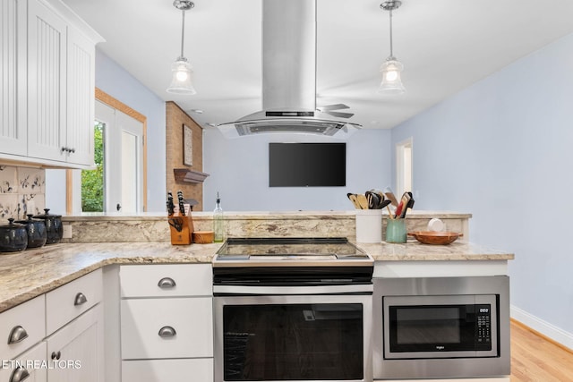 120 Cooper Cir, Oak Ridge, TN 37830 - kitchen with island range hood, appliances with stainless steel finishes, white cabinets, a peninsula, and light wood finished floors