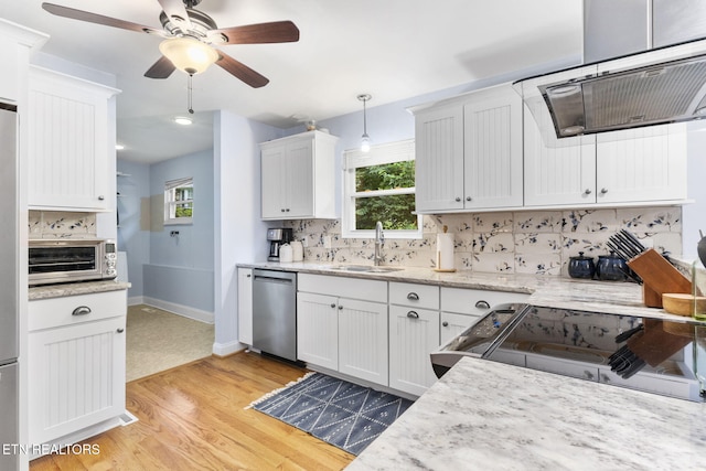 120 Cooper Cir, Oak Ridge, TN 37830 - kitchen featuring appliances with stainless steel finishes, ventilation hood, a sink, light wood-type flooring, and tasteful backsplash