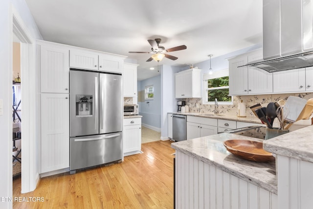 120 Cooper Cir, Oak Ridge, TN 37830 - kitchen with stainless steel appliances, wall chimney range hood, a sink, ceiling fan, and light wood-type flooring