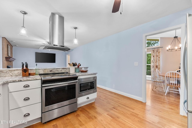 120 Cooper Cir, Oak Ridge, TN 37830 - kitchen featuring appliances with stainless steel finishes, island exhaust hood, ceiling fan, light wood-style floors, and white cabinets