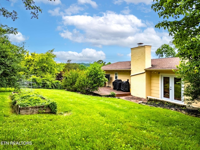 120 Cooper Cir, Oak Ridge, TN 37830 - view of green lawn featuring a wooden deck and a garden