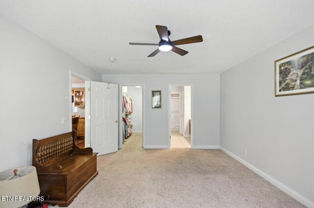 153 Creed Way, New Tazewell, TN 37825 - unfurnished bedroom featuring a walk in closet, light carpet, a closet, ensuite bath, and a ceiling fan