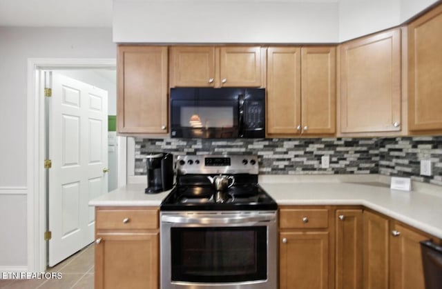153 Creed Way, New Tazewell, TN 37825 - kitchen with black microwave, stainless steel range with electric cooktop, light countertops, and tasteful backsplash