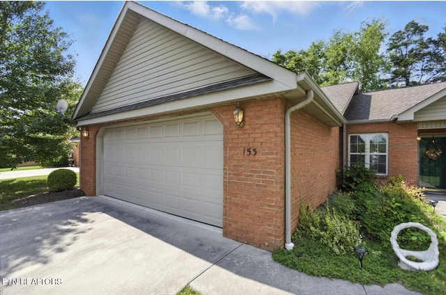 153 Creed Way, New Tazewell, TN 37825 - view of side of home with brick siding, concrete driveway, and a garage
