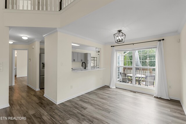 1213 Vale View Rd, Knoxville, TN 37922 - unfurnished living room with crown molding, dark wood finished floors, a chandelier, and baseboards