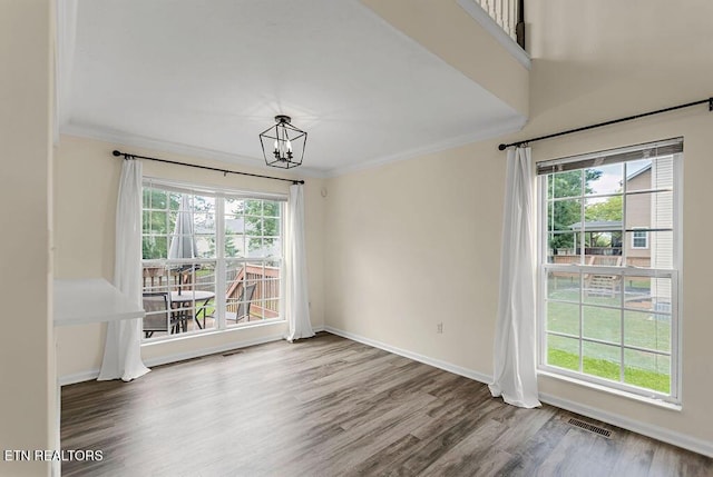 1213 Vale View Rd, Knoxville, TN 37922 - unfurnished dining area with crown molding, healthy amount of natural light, a chandelier, wood finished floors, and baseboards