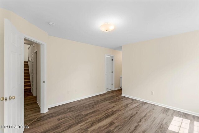 1213 Vale View Rd, Knoxville, TN 37922 - spare room featuring wood finished floors, baseboards, stairway, and a smoke detector