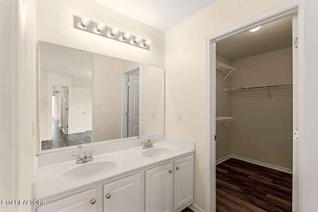 1213 Vale View Rd, Knoxville, TN 37922 - bathroom with double vanity, wood finished floors, a walk in closet, and baseboards