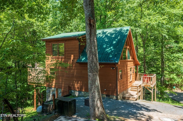 2261 Beach Front Dr, Sevierville, TN 37876 - view of side of home featuring a deck, a wooded view, and metal roof
