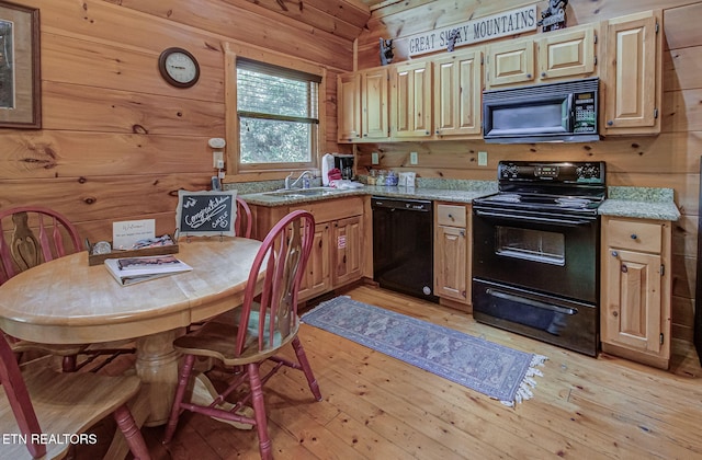 2261 Beach Front Dr, Sevierville, TN 37876 - kitchen featuring black appliances, a sink, wooden walls, light wood-style floors, and light countertops