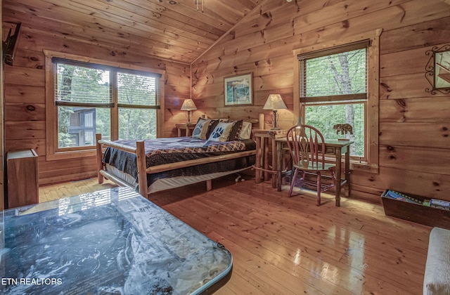 2261 Beach Front Dr, Sevierville, TN 37876 - bedroom featuring multiple windows, vaulted ceiling, wood-type flooring, wooden walls, and wooden ceiling